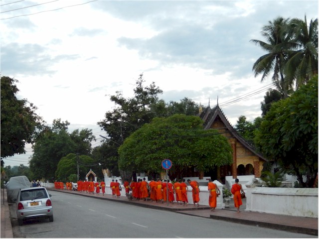 SE Asia Tour 2014 Each morning the monks proceed through the streets collecting alms from the locals. It is a religious ceremony, not a tourist attraction...