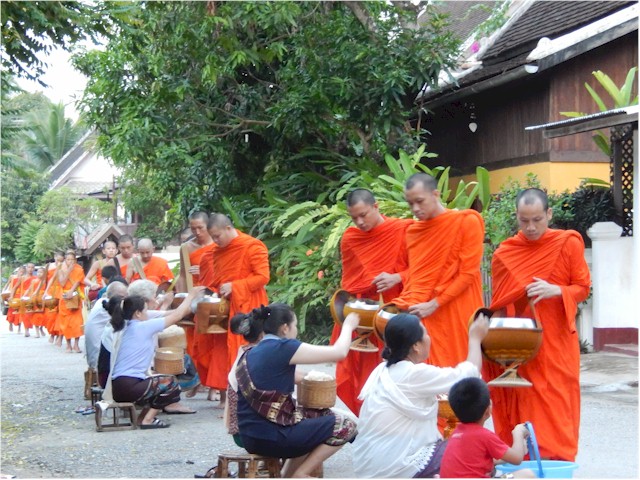SE Asia Tour 2014 It appeared mainly to be cooked rice or fruit which was given. Then taken back to the monasteries for eating.