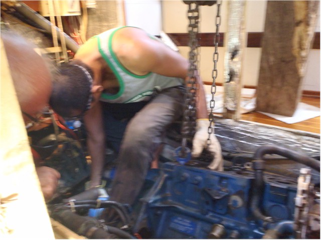 Matt & Keith lifting the engine back into the engine bay - with the help of a chain hoist suspended athwart the engine bay.