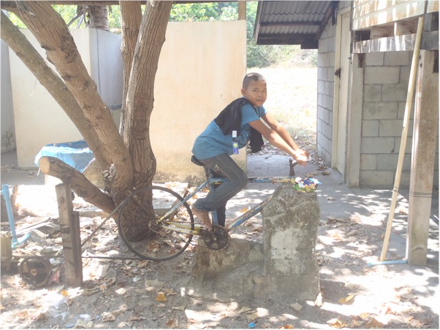 This young lad demonstrates how they power the pump to raise drinking water from the well.