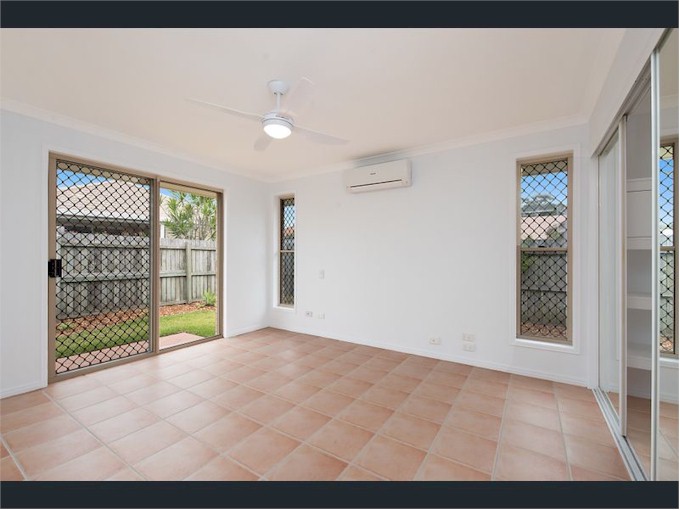 The master bedroom also has sliding doors out to another small patio, and a walk-in wardrobe behind the mirror doors on the right..