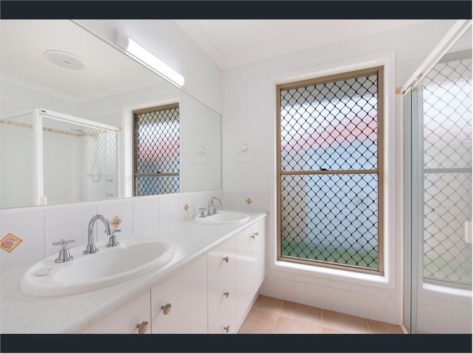 ... through the walk-in robe to the en-suite bathroom, complete with dual handbasins!