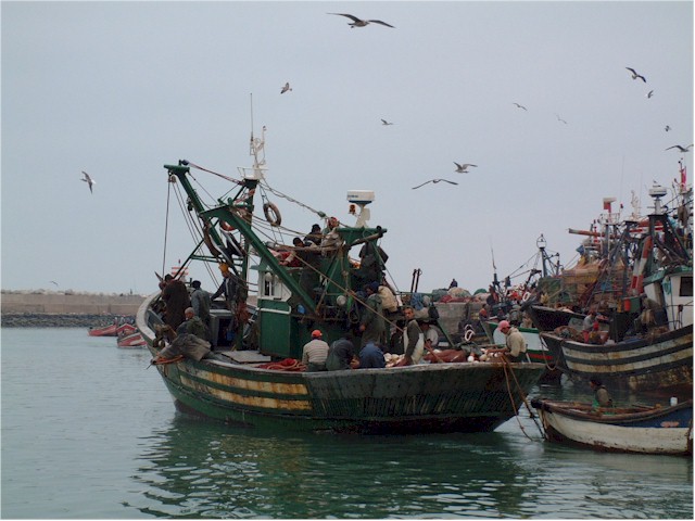One of the local fishing boats leaving port - with a very large crew to share in the catch!