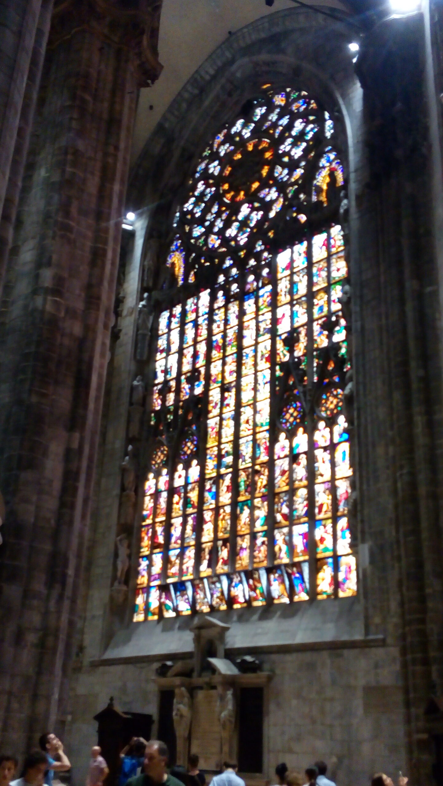 The beautiful, colorful stained-glass windows reflect an ethereal light on the floor of the church.
