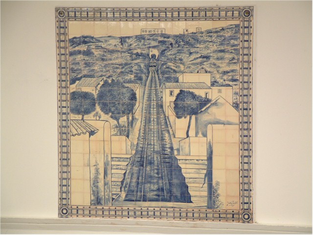 
a wall mural made up of traditional blue and white tiles.