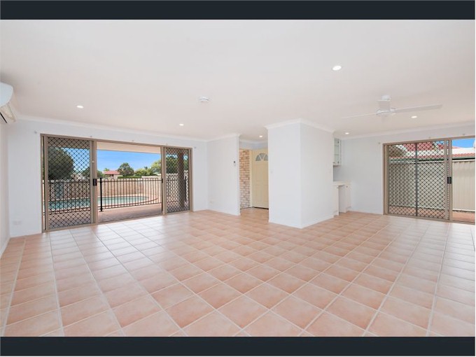 This is the lounge area with outside entertainment patio overlooking the pool, entrance hall and dining area with sliding doors out to another courtyard.