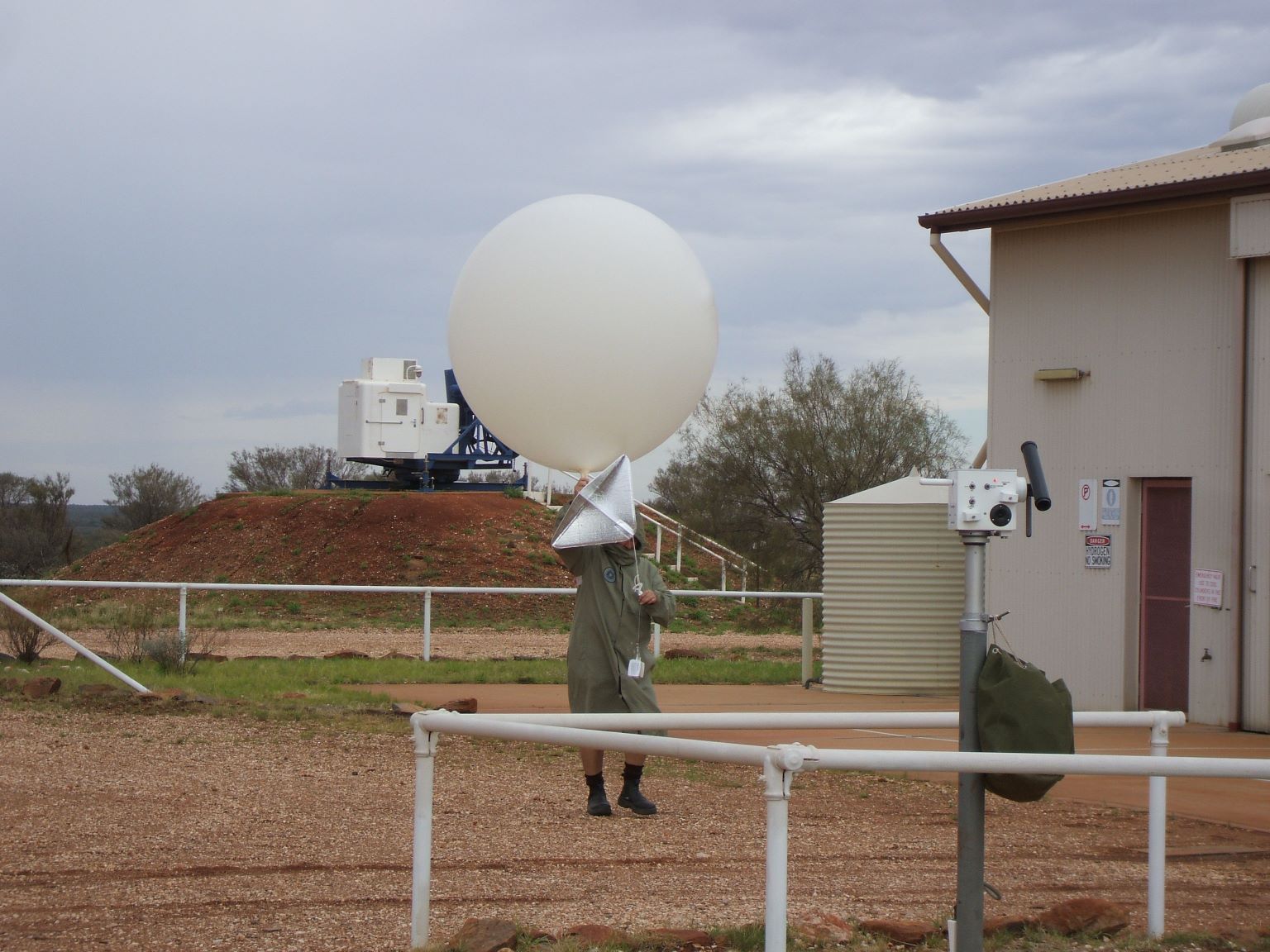 
Sending up the weather balloon which transmits its readings back to earth as it ascends...