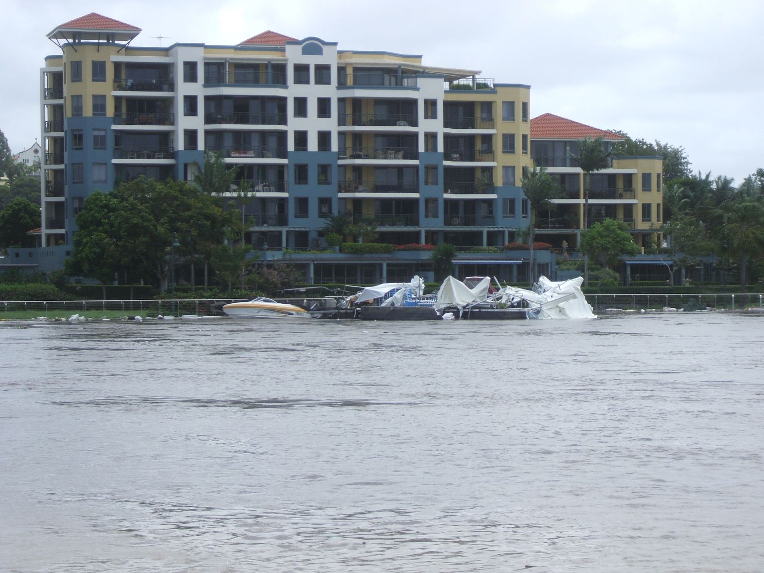 A floating restaurant broke its mooring and was smashed under a low bridge.