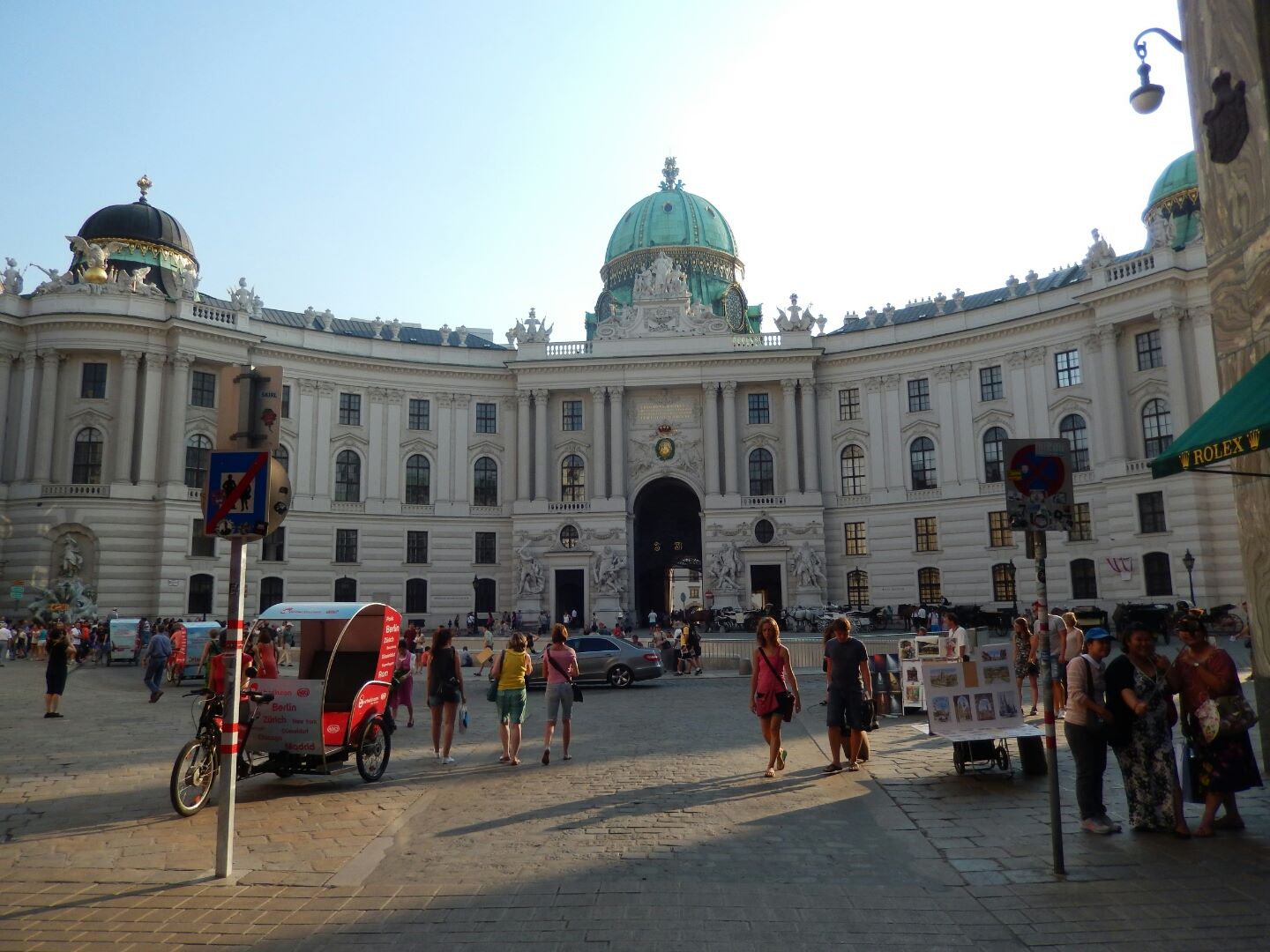 St. Michael Square and Hofburg Palace. Originally a medieval fortified castle dating from the 13th century, the Hofburg was extended by each emperor. The sprawling, asymmetric complex which extends over 240,000 m² consists of 18 wings, 19 courtyards and 2,600 rooms in which nearly 5,000 people still work and live today.
