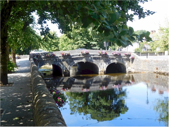 Pretty hanging baskets decorate the old stone bridge.
